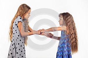 Two girls fight, grabbing each other`s fists