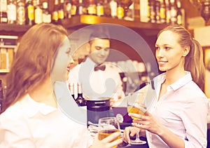 Two girls flirting with barman