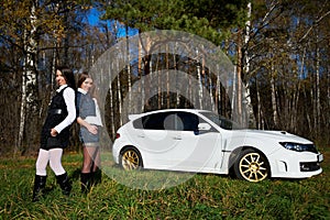 Two girls friend and stylish white sports car