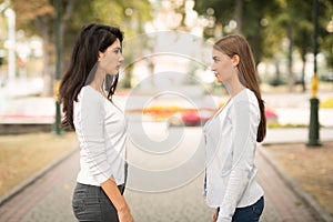 Two Girls Friends Having Conflict Standing Outdoors After Quarrel