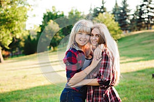 Two girls friends laughing and hugging. Hug and smile