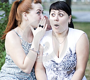 Two girls gossip