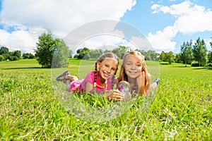 Two girls in the grass with butterfly