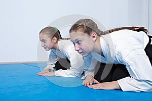 Two girls in hakama bow on Aikido training