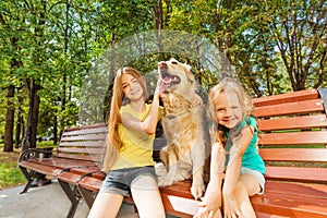 Two girls with happy dog