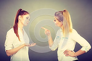 Two girls having argument, interpersonal conflict