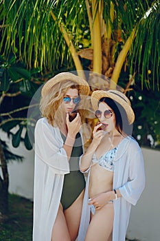 Two girls having fun by the pool