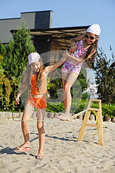 Two girls having fun on sling