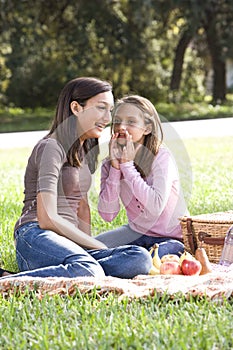 Two girls having picnic in park