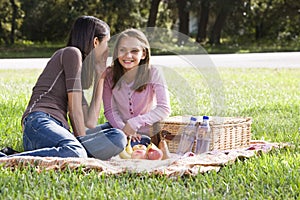 Two girls having picnic in park