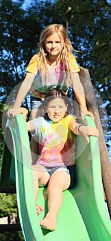 Two girls having rest on slide