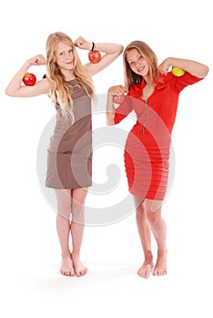 Two girls holding apples on her biceps