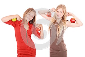 Two girls holding apples on her biceps