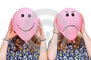 Two girls holding pink balloons with facial expressions for head