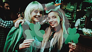 Two Girls Holding A Shamrocks. St Patrick`s Day