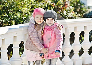 Two girls hugging outdoors