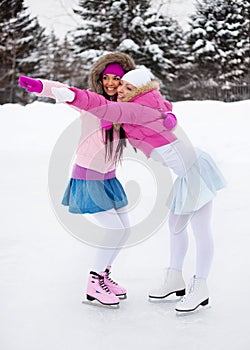 Two girls ice skating