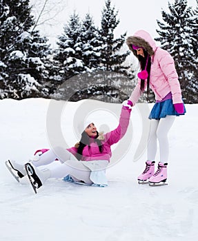 Two girls ice skating