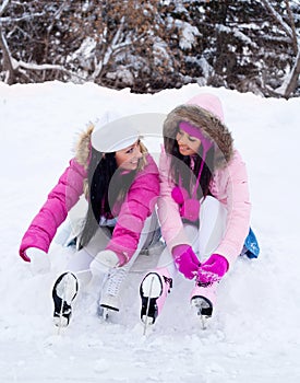 Two girls ice skating