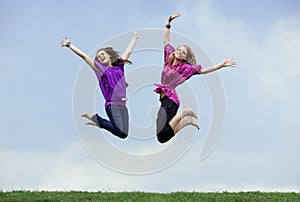 Two girls jumping