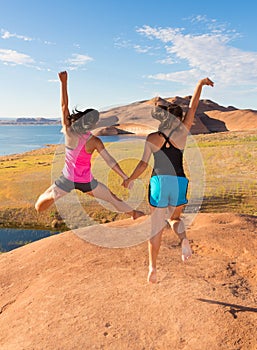 Two Girls Jumping in Celebration