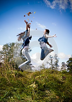 Two girls jumping high excited