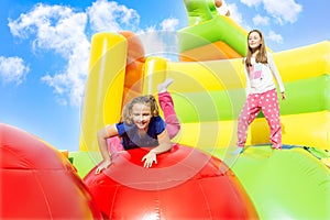 Two Girls Jumping on Inflate Castle Cloudscape