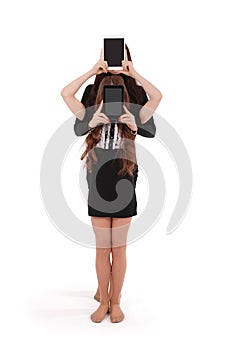 Two girls keeps tablet pc in front of face