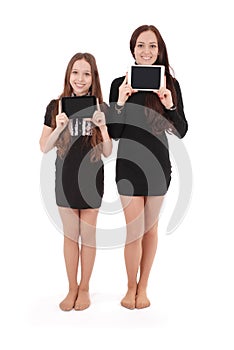 Two girls keeps tablet pc in front of yourself