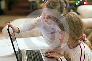 Two girls and laptop computer