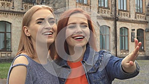 Two girls Laughing at something in front of them