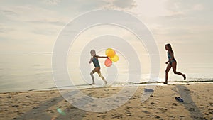 Two girls laughing together. Playing on the beach, catching up with each other