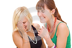 Two girls laughing on white background