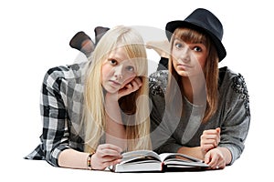 Two girls lies and read books