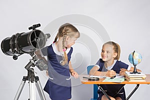 The two girls looked at each other in the classroom Astronomy photo
