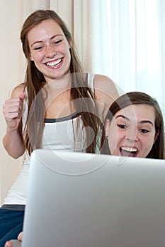 Two girls looking at a lap top.