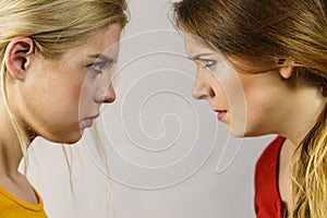 Two girls looking serious at each other