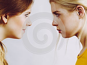 Two girls looking serious at each other