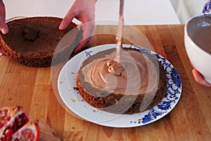 Two girls making a cake on the kitchen.