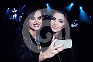 Two Girls Making Selfie on Music Party Background