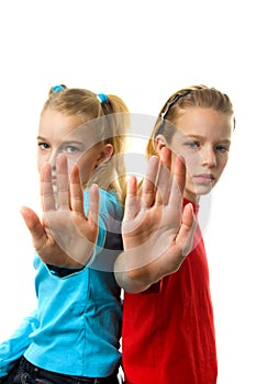 Two girls making stop sign