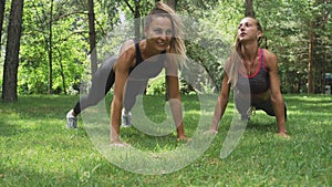 Two Girls Making Yoga Pose Downward Facing Dog