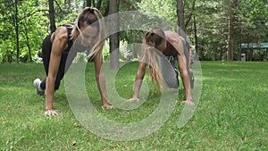 Two Girls Making Yoga Pose Downward Facing Dog