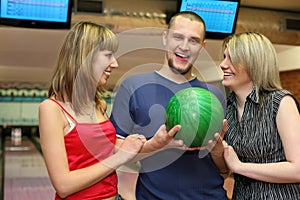 Two girls and man stand alongside and laugh