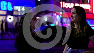 Two girls at Miami Beach at night - the colorful Ocean Drive of South Beach