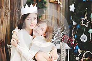 Two girls near Christmas tree