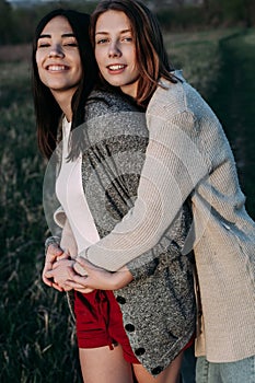 Two girls outdoors at sunset