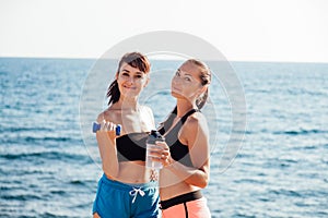 Two girls play sports on the beach