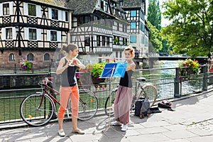 Two girls playing flute on the street in Strasbourg