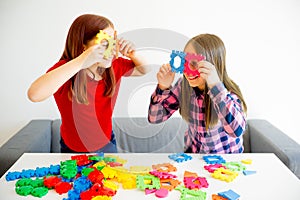 Two girls playing lego